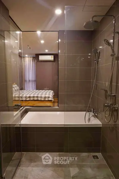 Modern bathroom with glass shower and bathtub in luxury apartment