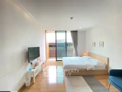 Spacious bedroom with balcony and modern decor in a bright apartment