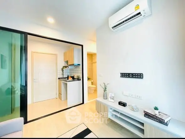 Modern apartment interior with open layout, featuring air conditioning and stylish decor.
