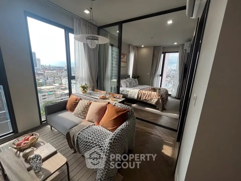 Modern apartment with cozy living room and stylish bedroom, featuring large windows and city views.