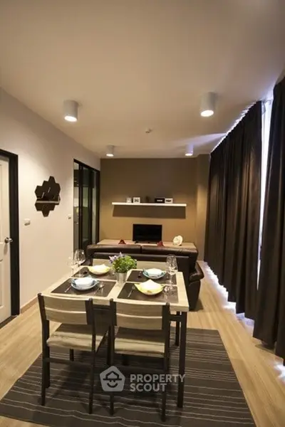 Modern living room with dining area, stylish decor, and cozy ambiance.