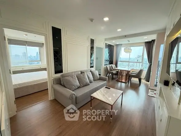 Modern living room with city view, elegant decor, and spacious layout.