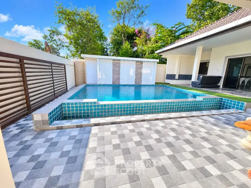 Luxurious private pool area with modern design and spacious patio in a serene residential setting.