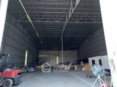 Spacious industrial warehouse with high ceilings and ample storage space.
