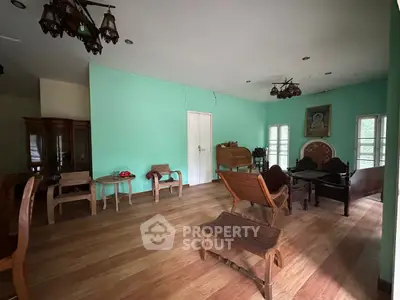 Charming vintage living room with wooden furniture and mint green walls