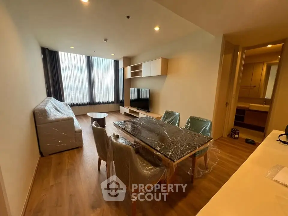 Spacious modern living room with dining area and large windows