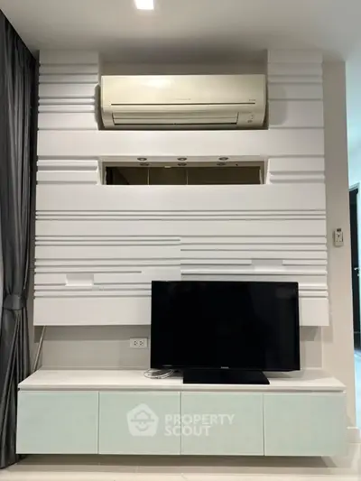 Modern living room with sleek TV unit and air conditioning