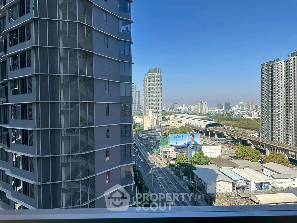 Stunning cityscape view from a high-rise balcony showcasing urban skyline and modern architecture.