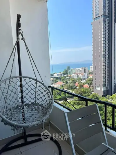 Stunning balcony view with modern high-rise and ocean backdrop