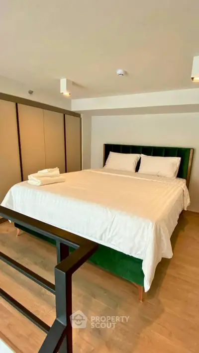 Spacious bedroom with modern design and elegant furnishings in a stylish apartment.