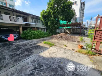 Spacious residential driveway with greenery and parking space in urban setting