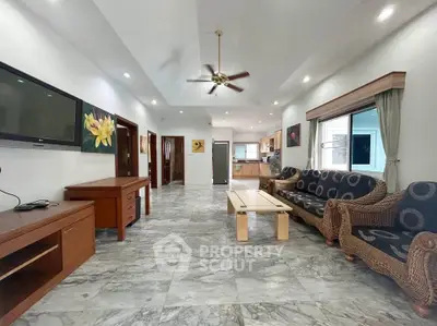 Spacious living room with modern decor and marble flooring