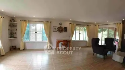 Spacious living room with large windows and elegant decor