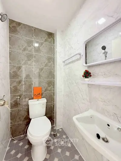 Modern bathroom with elegant tile design and sleek fixtures