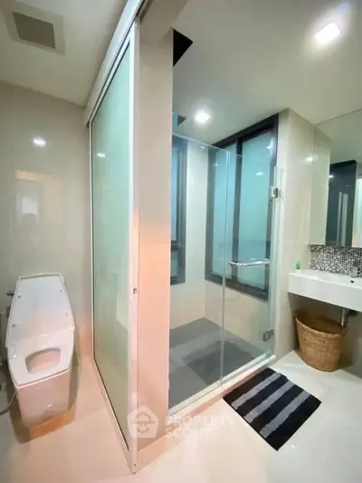 Modern bathroom with glass shower and sleek fixtures