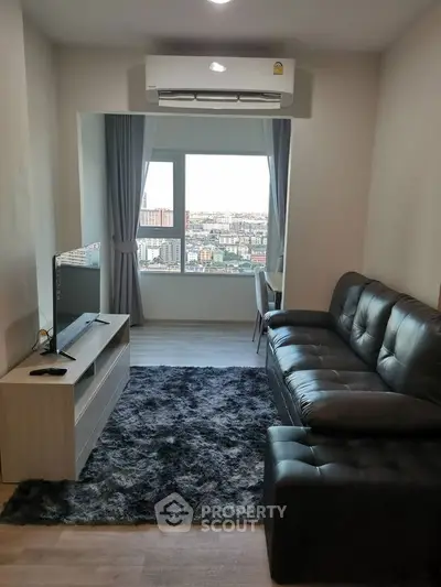 Modern living room with city view, sleek furniture, and cozy ambiance.