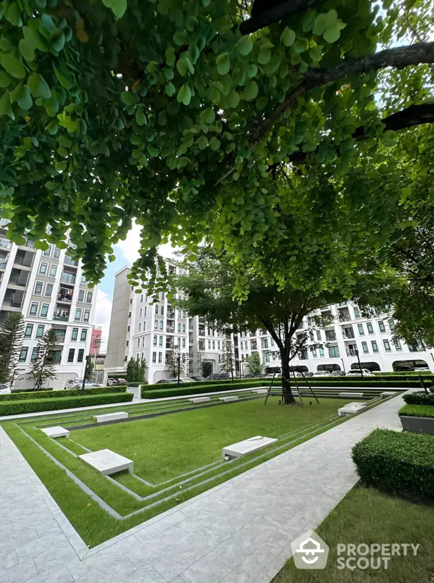 Luxurious garden view in modern residential complex with lush greenery and elegant architecture