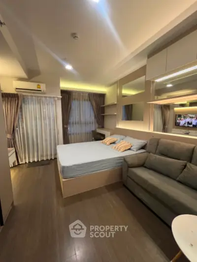 Modern bedroom with cozy sofa and stylish decor in a well-lit apartment