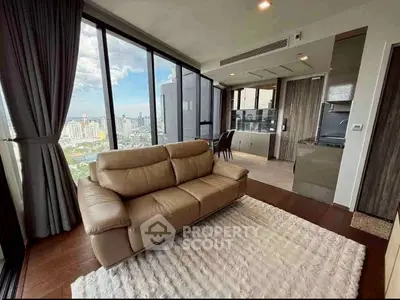 Luxurious high-rise living room with stunning city view and modern open kitchen layout.