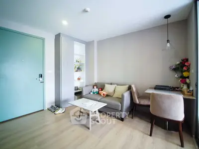 Modern living room with cozy sofa and dining area, featuring stylish decor and natural light.