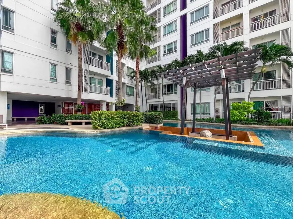 Luxurious apartment complex with stunning pool and lush landscaping, perfect for relaxation and leisure.