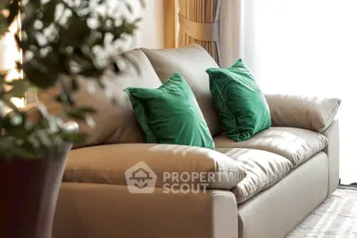 Elegant living room with plush beige sofa and vibrant green cushions