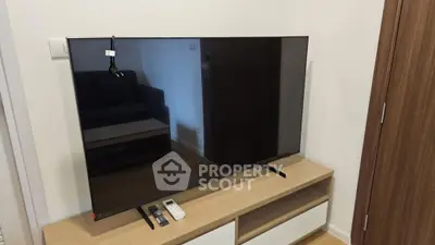 Modern living room with sleek TV setup on stylish wooden stand, perfect for entertainment.