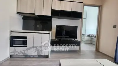 Modern compact living room with sleek cabinetry and integrated TV unit