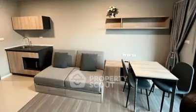 Modern living room with compact kitchen and dining area in stylish apartment