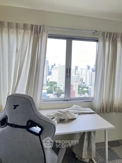 Modern study room with city view from high-rise apartment window