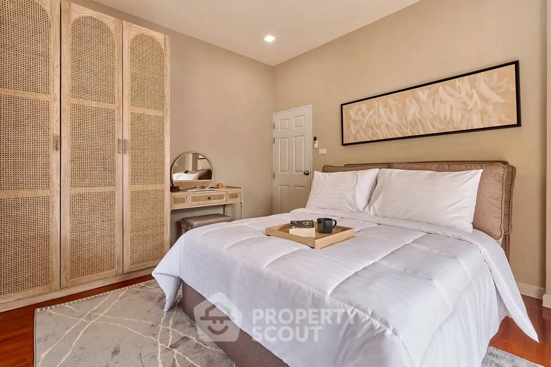 Cozy bedroom with elegant decor and stylish furniture, featuring a comfortable bed and chic wardrobe.