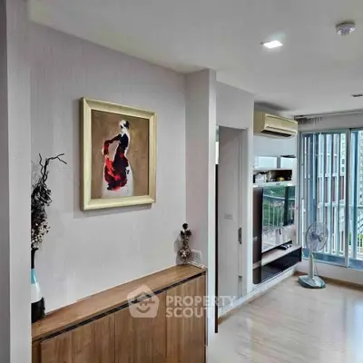 Modern living room with stylish decor and large windows offering natural light.