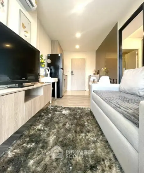 Modern living room with cozy sofa and stylish decor in a contemporary apartment.