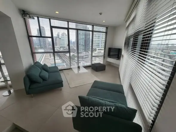 Spacious modern living room with panoramic city views and stylish furniture.