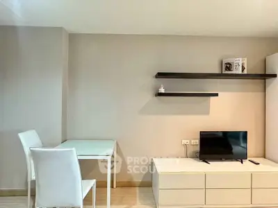 Modern living room with minimalist furniture and wall-mounted shelves, perfect for urban living.