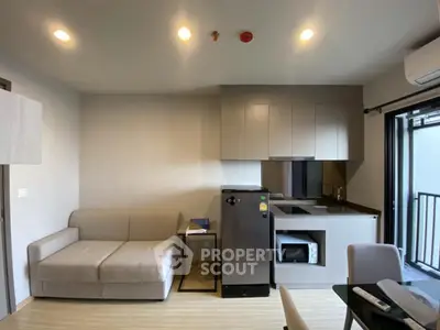 Modern studio apartment with compact kitchen and cozy living area