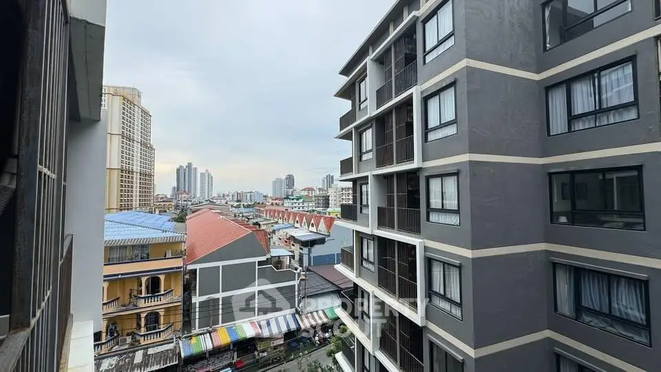 Urban cityscape view from a high-rise building with modern architecture and vibrant neighborhood.