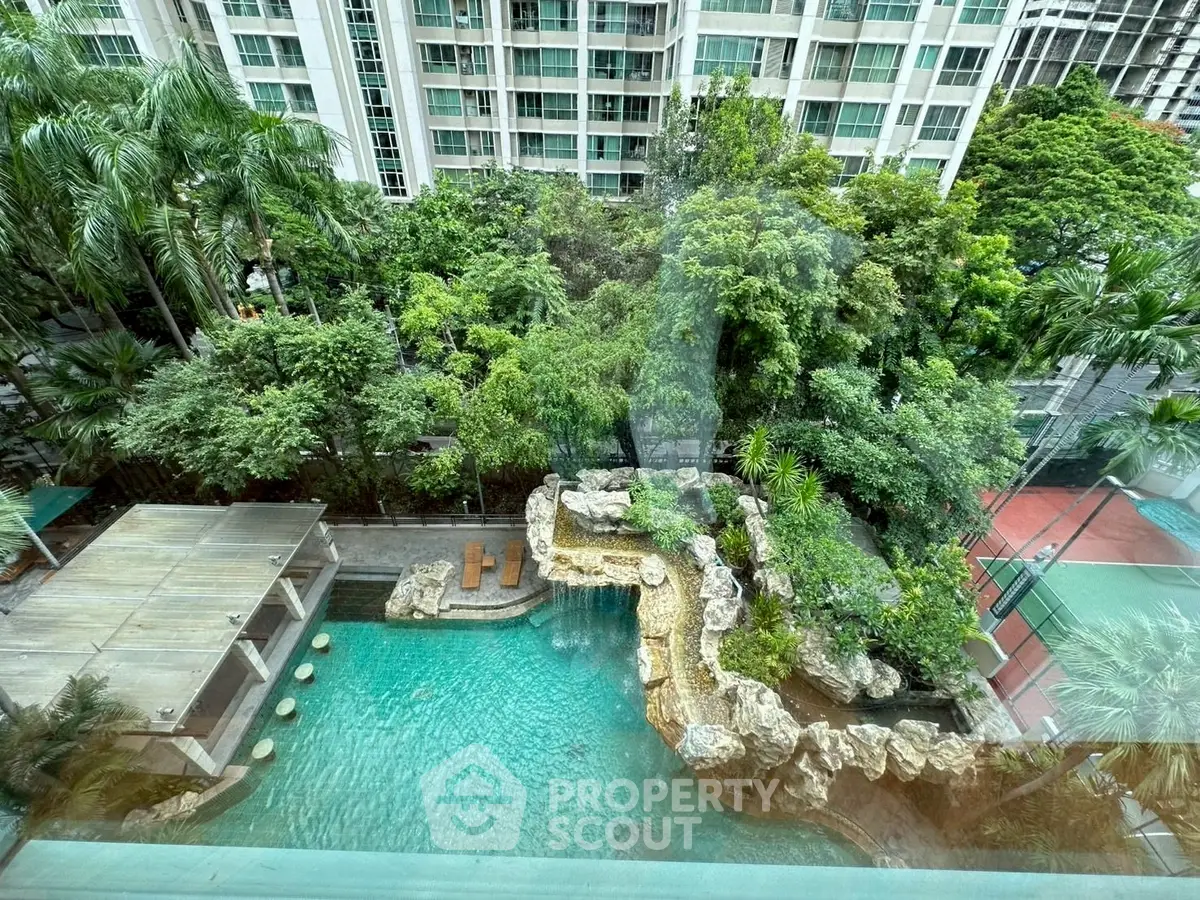 Luxurious condo with stunning pool and lush greenery view