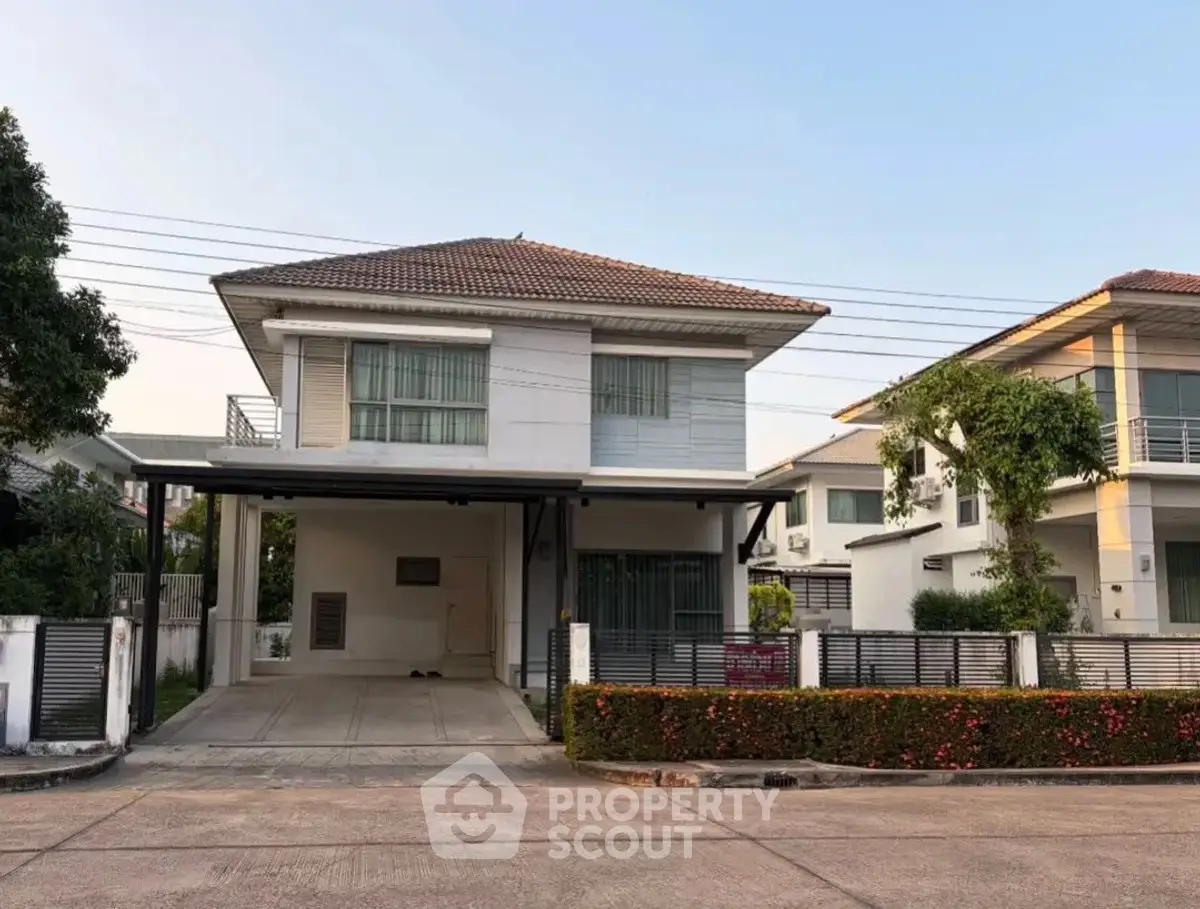 Charming two-story house with modern design and spacious driveway in a serene neighborhood.