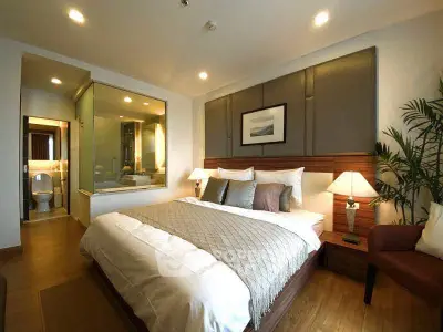 Luxurious bedroom with elegant decor and en-suite bathroom in modern apartment.