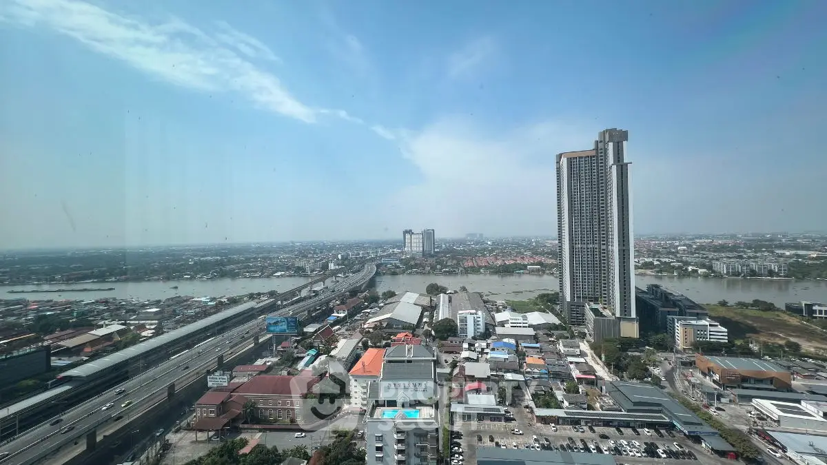 Stunning high-rise cityscape view with river and skyline, perfect for urban living.