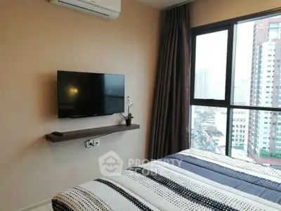 Modern bedroom with city view, wall-mounted TV, and air conditioning in a high-rise apartment.