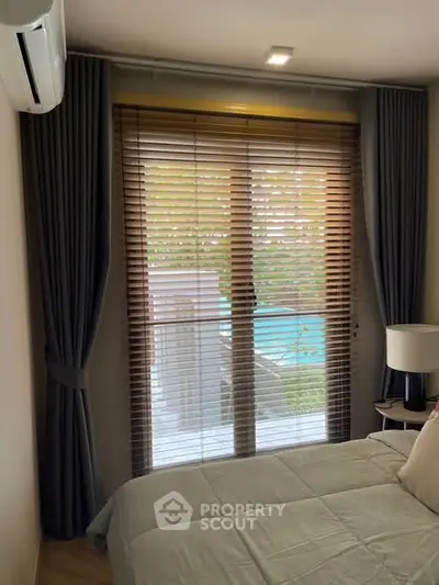 Cozy bedroom with pool view through elegant blinds and curtains