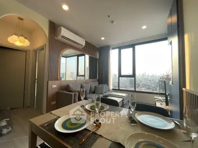 Modern living room with city view, stylish decor, and dining area in high-rise apartment