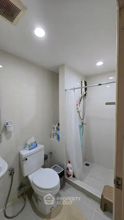 Modern bathroom with shower and toilet in a compact layout