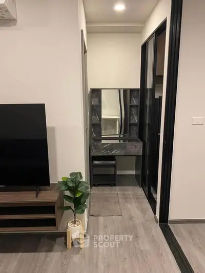Modern living room with sleek TV stand and stylish decor in a contemporary apartment.