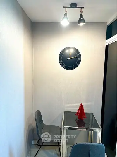Cozy study nook with modern decor and stylish clock, perfect for focused work or reading.