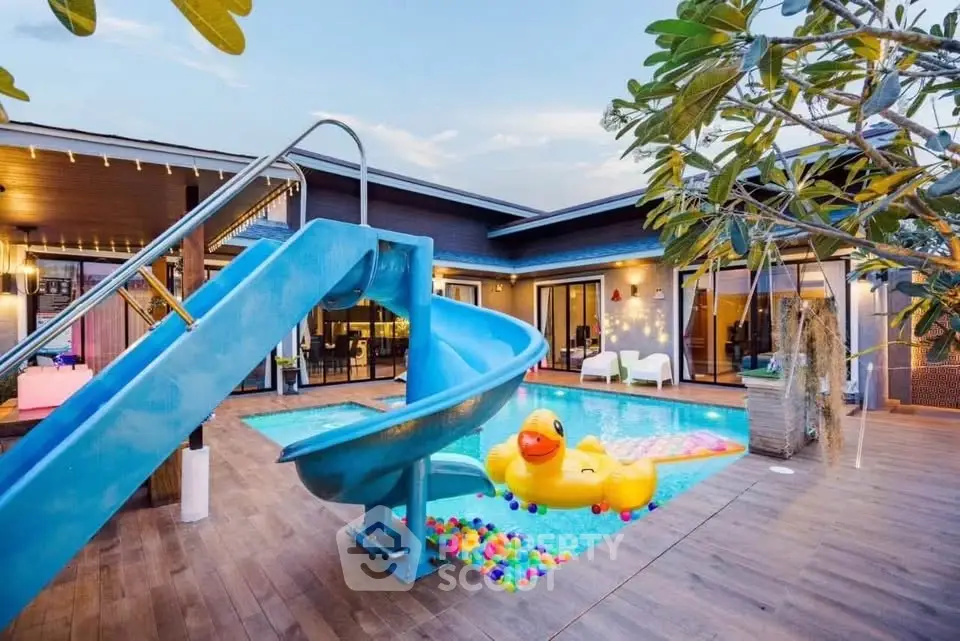 Luxurious villa with private pool, slide, and vibrant outdoor space for ultimate relaxation and entertainment.