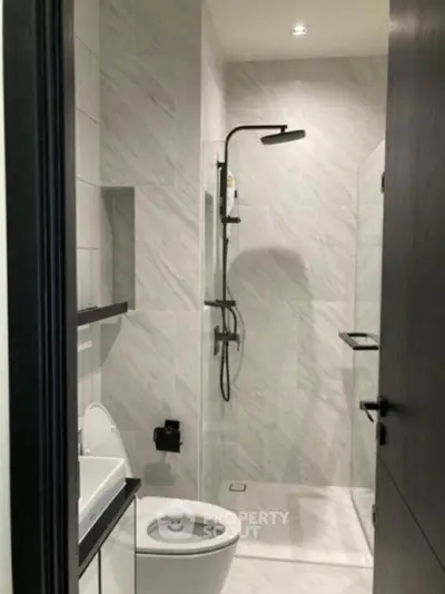Modern bathroom with sleek shower and elegant marble tiles