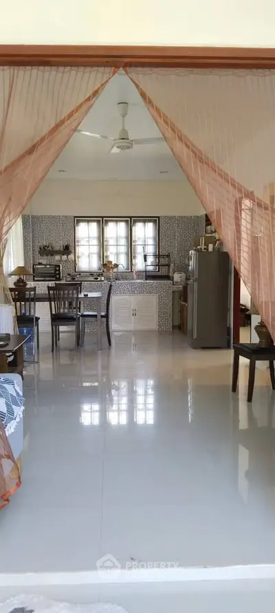Spacious open-layout kitchen and dining area with modern decor and natural light.